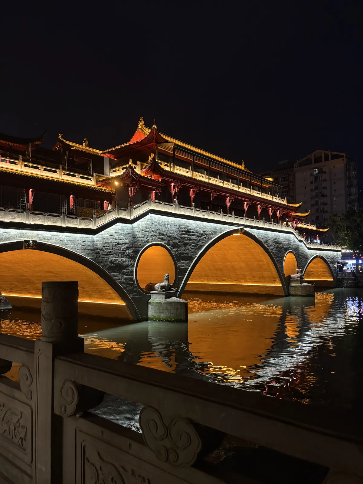 Anshun Bridge lit up at night over the river
