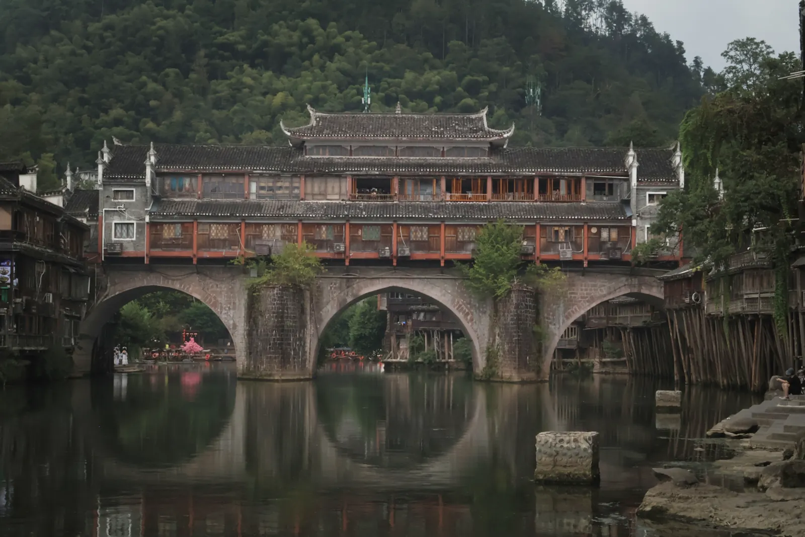 The covered bridge of Fenghuang reflected in the river