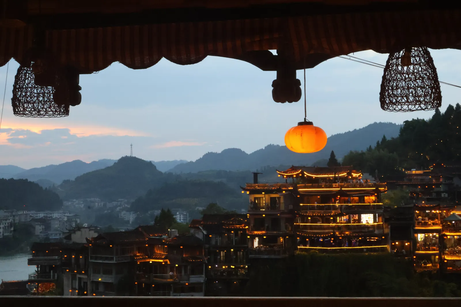 Lanterns and lit-up wooden houses of Furong at dusk